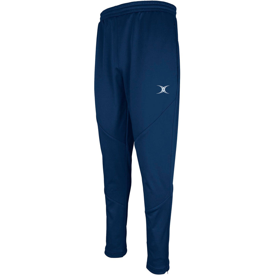 The Gilbert Pro Warm Up Trouser by Gilbert in navy features technical fabric, an elastic waistband, and a small white logo on the left thigh, displayed against a white background.