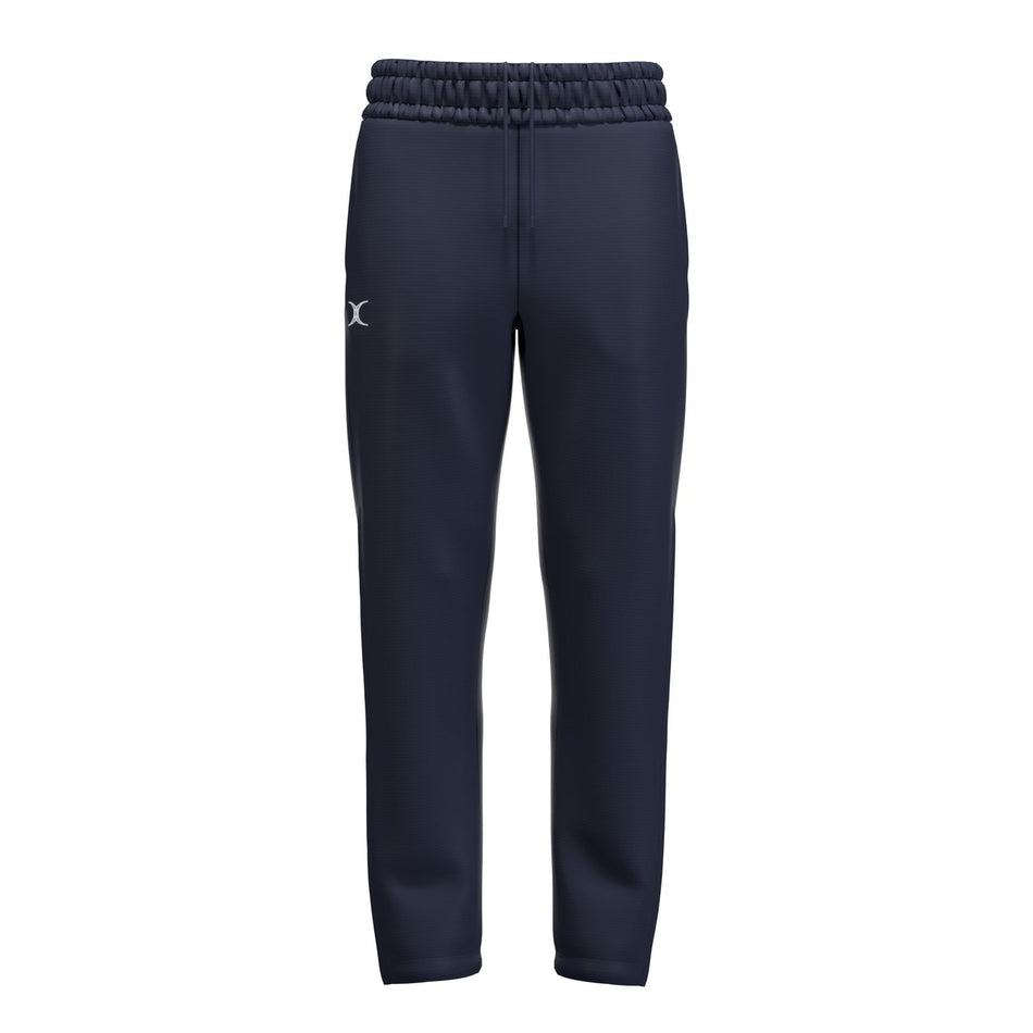The Gilbert Atom Track Trousers by Gilbert are navy blue coaching travel pants with an elastic waistband, drawstring, and a small white logo on the upper left thigh, made from recycled polyester. Shown against a plain white background.