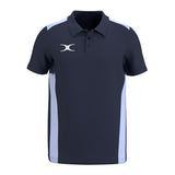 The Gilbert Atom Polo Shirt by Gilbert is a navy blue, short-sleeve polo with moisture-wicking fabric, light blue side panels, a collar, buttons, and a white stylized logo on the left chest for a modern look.