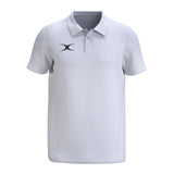 The Gilbert Atom Polo Shirt by Gilbert is a plain white, moisture-wicking short-sleeve polo with a collar, three buttons, and a small black logo on the left chest.