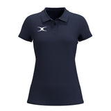 The Gilbert Atom Polo - Womens by Gilbert is a navy blue casual polo featuring short sleeves, a collar, three buttons, and a white left chest logo. Made from recycled polyester with moisture wicking, it’s shown on a plain white background.