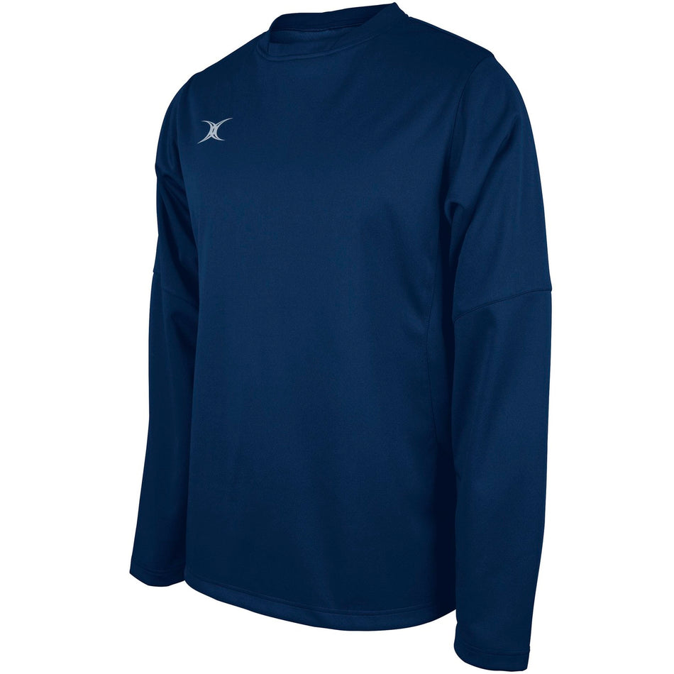 The Gilbert Pro Warm Up Top by Gilbert is a navy long-sleeve athletic shirt with a crew neckline and a small white chest logo, made from breathable stretch material. Displayed on a plain white background.