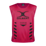 The Gilbert Tackle Zone Bib is a sleeveless red rugby training bib with "GILBERT" and "TACKLE ZONE" printed in black, black chevron stripes on both sides, and a large black logo—perfect for practicing tackle height regulations.