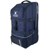 The navy Gilbert Club Tour Wheeled Holdall sports bag features a white logo, two handles, zippered compartments, adjustable straps, and wheels for easy transport of sports equipment.