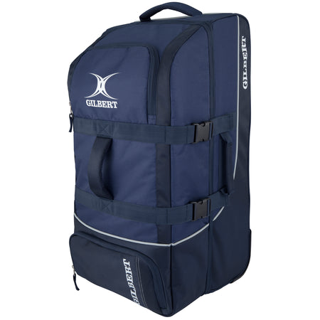 The navy Gilbert Club Tour Wheeled Holdall sports bag features a white logo, two handles, zippered compartments, adjustable straps, and wheels for easy transport of sports equipment.