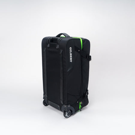 The Gilbert Club Tour Bag V4 is a large black wheeled rugby bag with a handle, green accents, and "GILBERT" printed vertically in white on the side, shown against a plain white background.