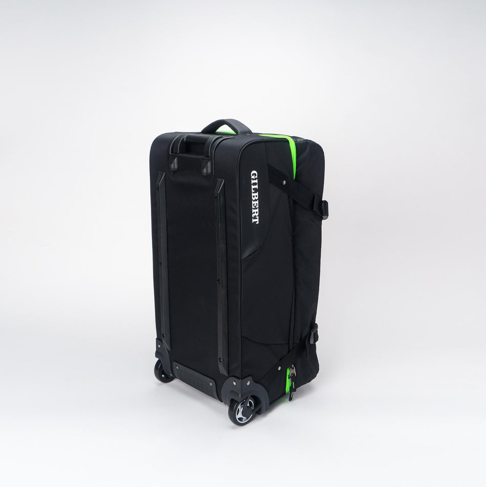 The Gilbert Club Tour Bag V4 is a large black wheeled rugby bag with a handle, green accents, and "GILBERT" printed vertically in white on the side, shown against a plain white background.