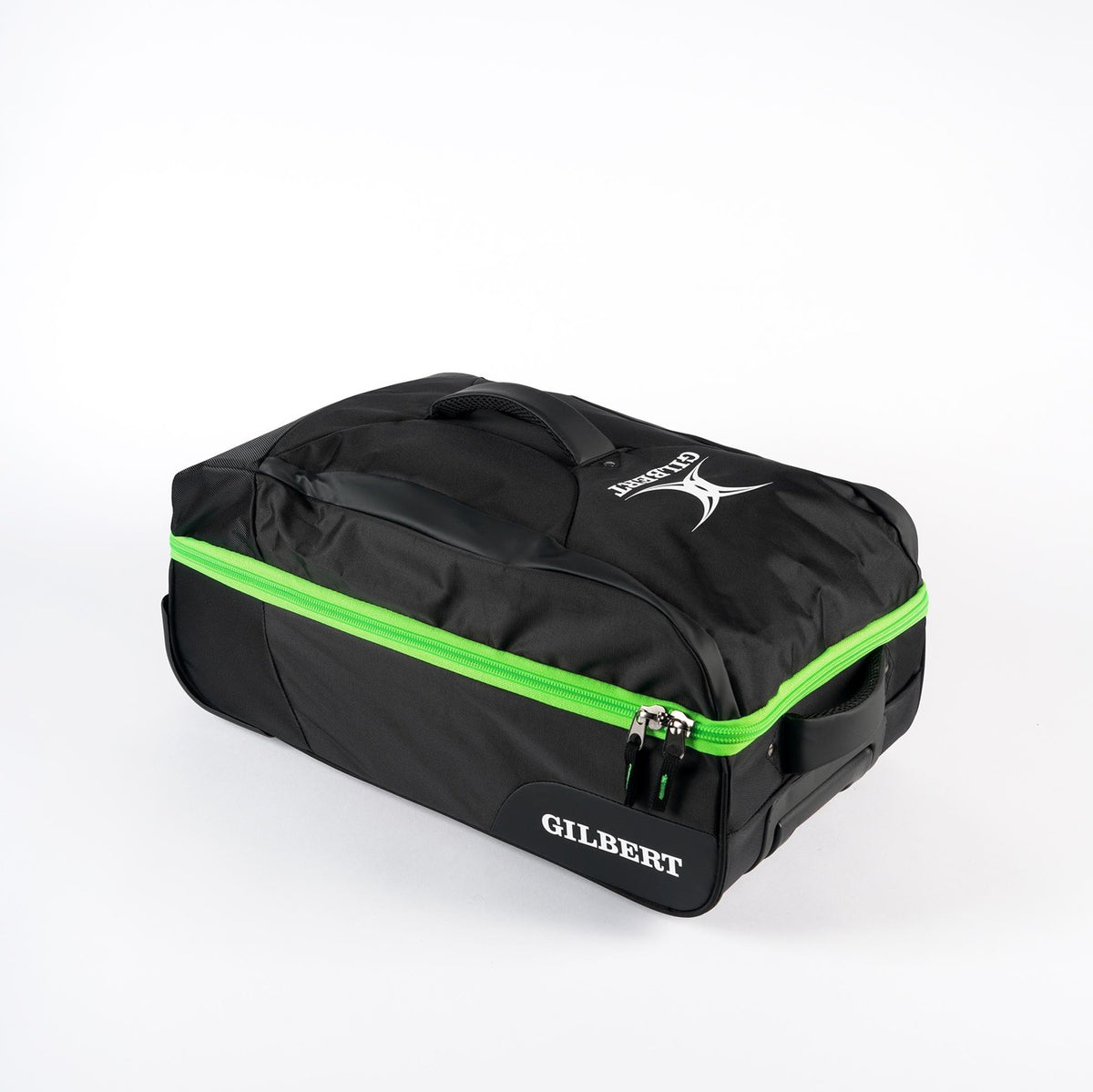The Gilbert Flight Bag by Gilbert is black with a bright green zipper, sectioned storage, a top handle, and features the logo and name in white; shown on a white background.