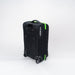 The Gilbert Flight Bag, by Gilbert, is black with green zippers, two wheels, sectioned storage, a top handle, and branding on the side. It is displayed against a plain white background.