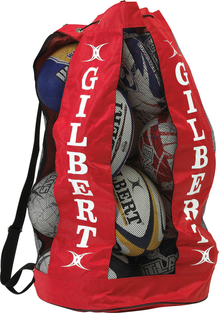 The Gilbert Breathable Ball Bag, in red and branded with Gilbert, holds multiple rugby balls and features a breathable, see-through mesh design with a strap for easy and organized sports ball storage.