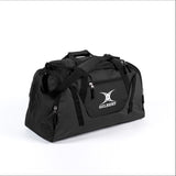 The Gilbert Club V4 Holdall in Black/Black features multiple zippered compartments, a shoulder strap, carry handles, and a front pocket with the white Gilbert logo—making it the perfect go-to sports bag.