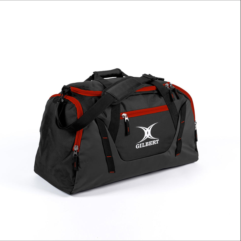 The Gilbert Club V4 Holdall by Gilbert in Black/Red features red zippers, a top handle, adjustable shoulder strap, and a white Gilbert logo on the front—perfect as a sports bag for any athlete.