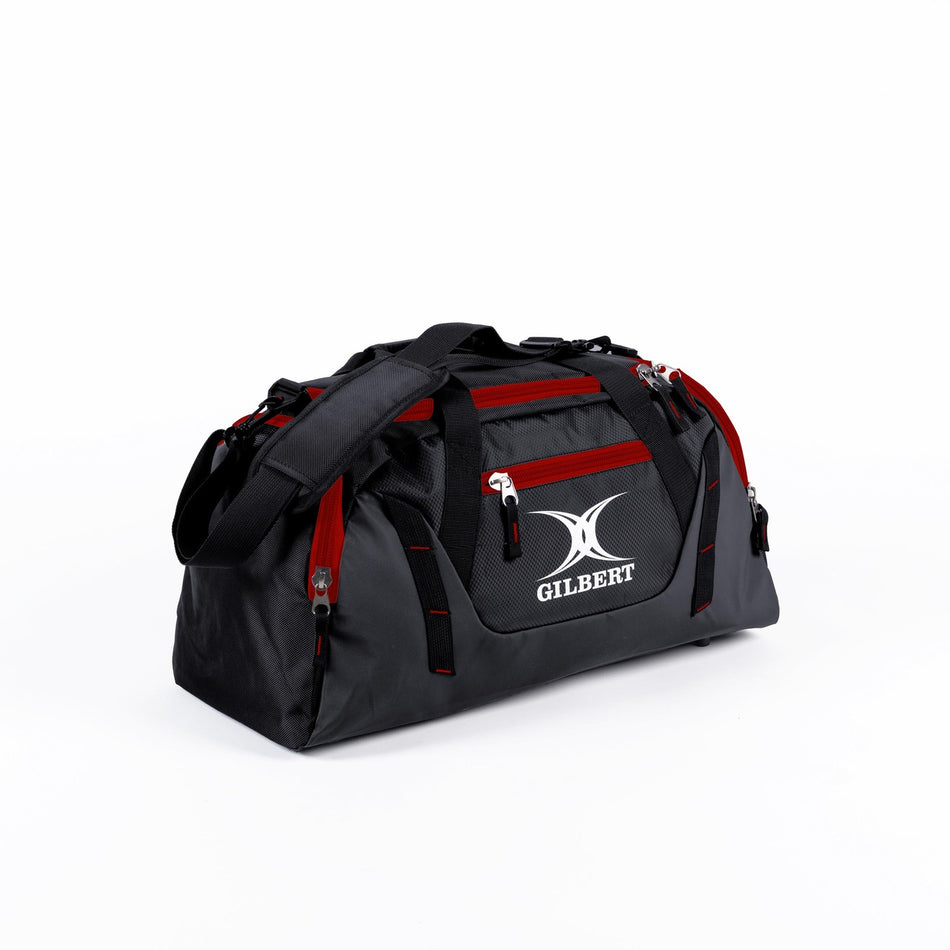 The Gilbert Club Players V4 Holdall by Gilbert in Black/Red features multiple zippered pockets, a shoulder strap, and the iconic GILBERT logo—an ideal durable sports holdall for any rugby player's bag collection.