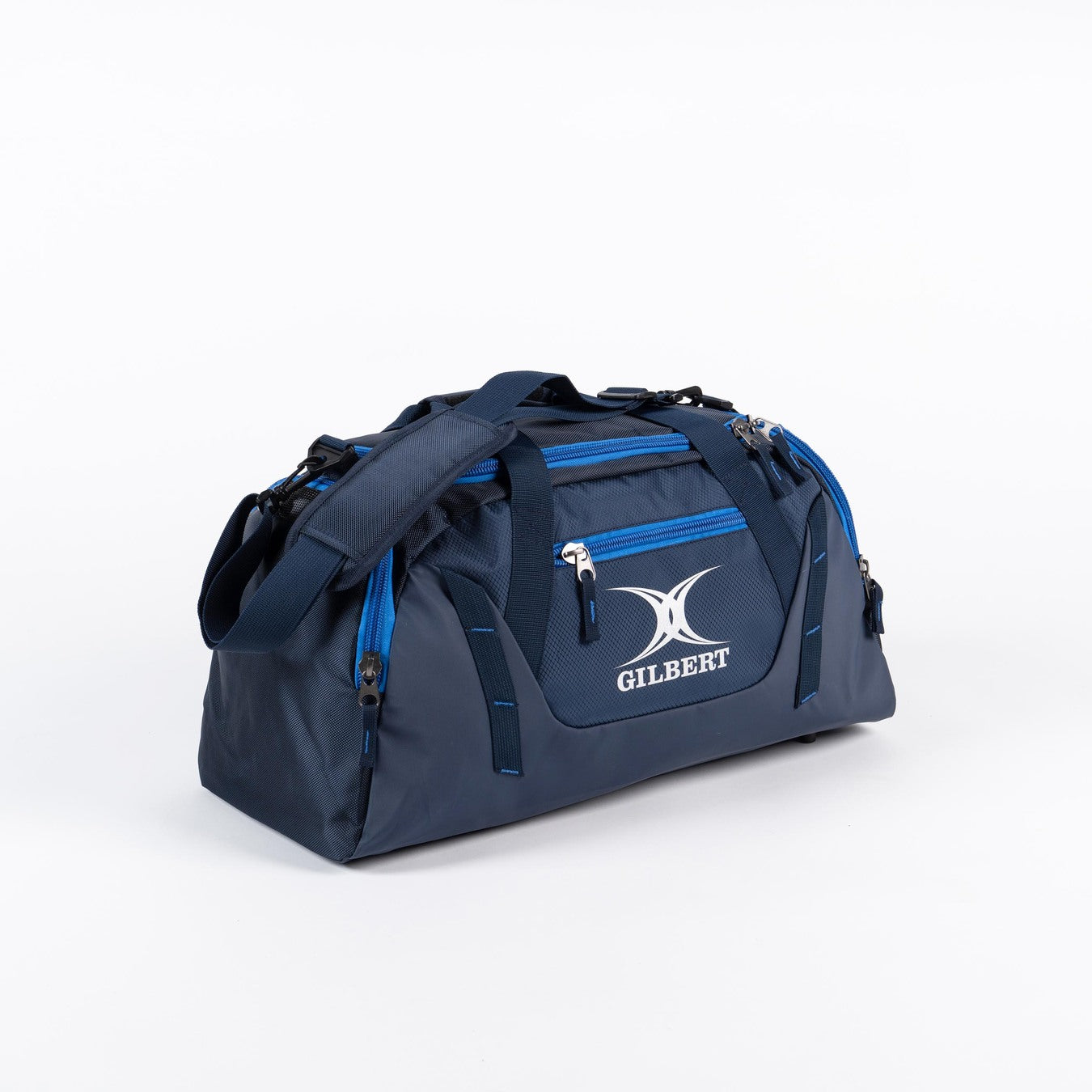 The Gilbert Club Players V4 Holdall is a navy/royal duffel bag with black handles, adjustable shoulder strap, blue zippers, and a front zip pocket displaying the Gilbert logo—perfect for any rugby player’s gear.