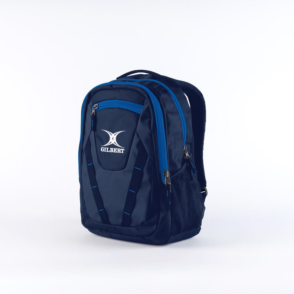 The Gilbert Club V4 Rucksack by Gilbert in Navy/Royal features multiple zippered compartments, side mesh pockets, and a top handle, showcased against a plain white background.