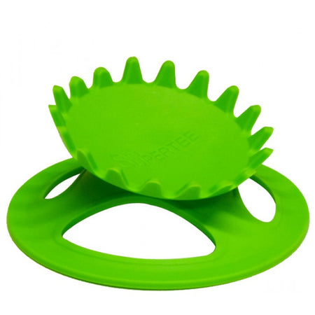 A vibrant green, round plastic Dan Carter Kicking Tee - Supertee Crown features a spiked, gear-like top with tapered teeth technology and sits angled on a flat base with three large cut-outs, blending modern design and playful inspiration from the SUPERTEE Crown.