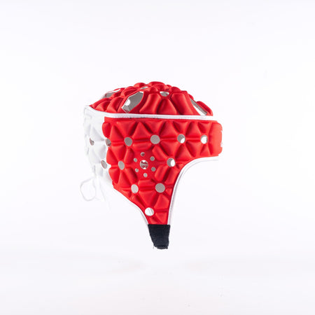 The Gilbert Air Headguard - Senior by Gilbert, featuring a red and white padded design with a geometric textured surface, is displayed against a plain white background.