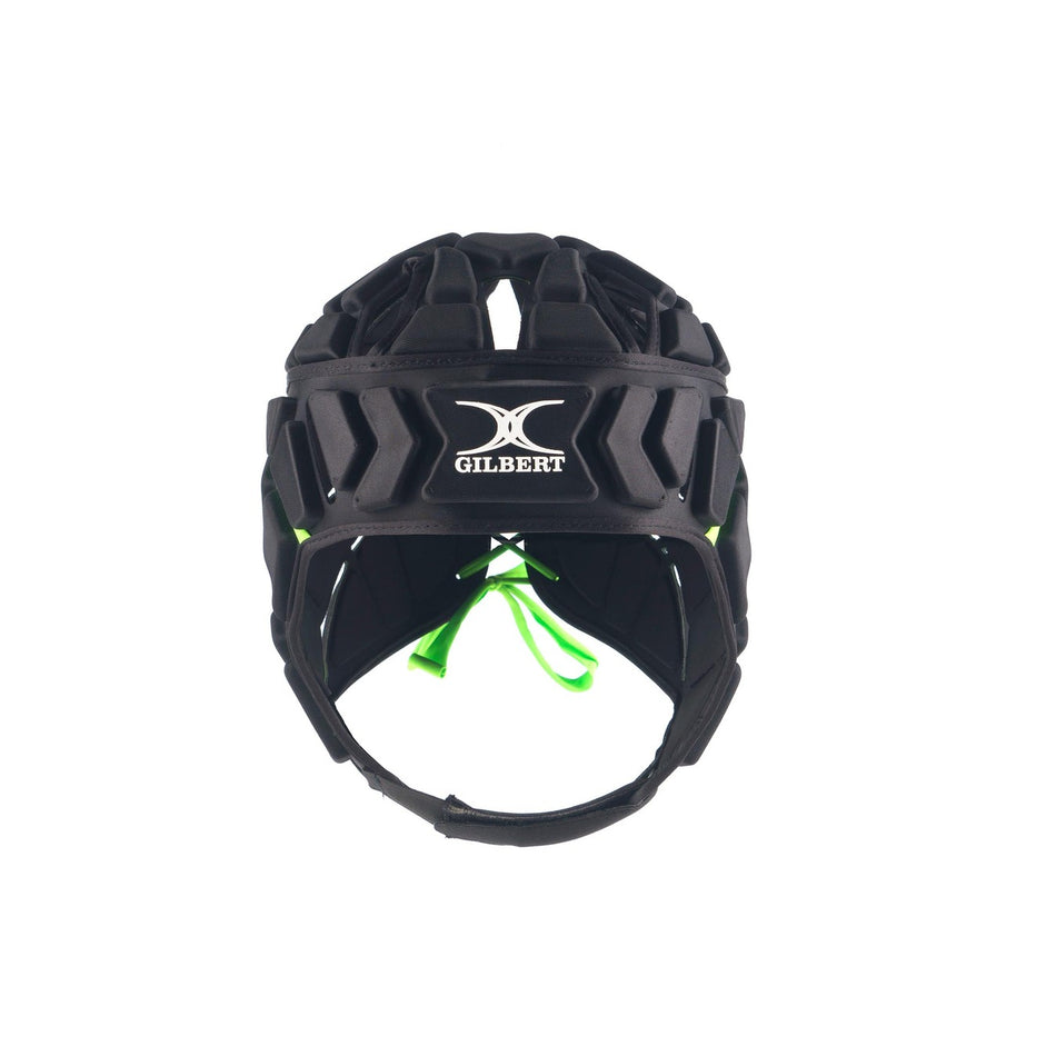 Front view of the black Gilbert Fusion Senior Headguard with shock-absorbing padding, ventilation holes, chin strap, and green inner accents. The Gilbert logo appears on the forehead.