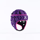 The Gilbert Octane Senior Headguard in purple/pink features hexagonal padding, pink trim, a white Gilbert logo, and an expandable lace closure, shown against a plain white background.