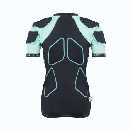 The Gilbert Triflex Lite V2 Womens Body Armour is a black, short-sleeve sports shirt with light teal padded shoulders and upper arms. It features Triflex Lite impact protection, outlined padding on the back and sides, and a fitted design for women’s rugby.