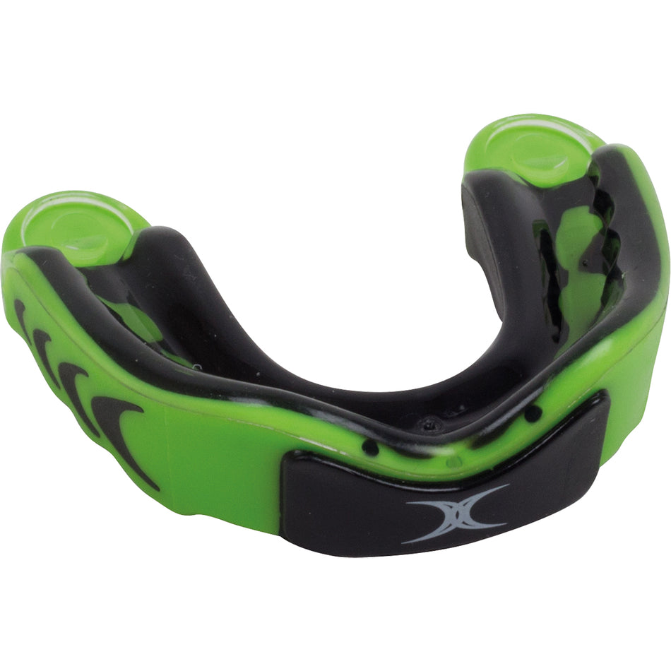The Gilbert Virtuo Triple Density Mouthguard by Gilbert is green and black with a black front section and white logo, designed to fit over upper teeth for enhanced concussion protection during sports.