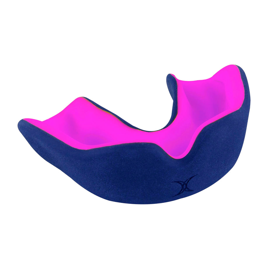 The Gilbert XBrace Dual Density Mouthguard by Gilbert, shown in navy/pink against a white background, is designed to protect teeth during sports activities.