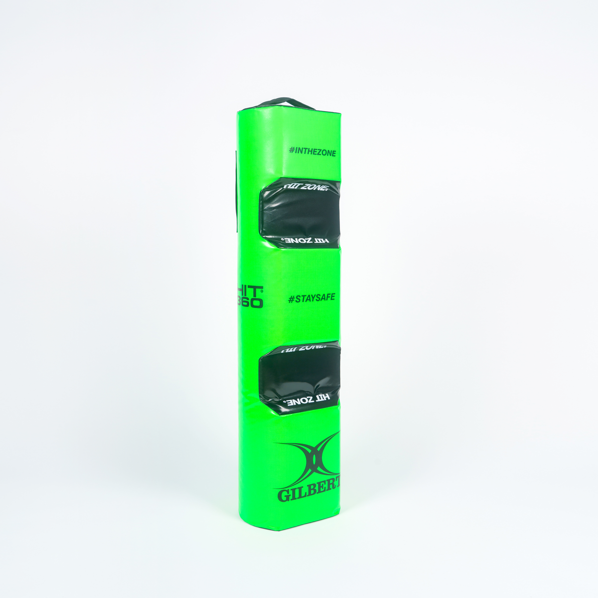 The Gilbert Hit 360 Tackle Bag is a bright green rectangular rugby tackle bag with two black handles and branded #INTHEZONE and #STAYSAFE—ideal for legal tackle training at the right height, shown upright on a white background.