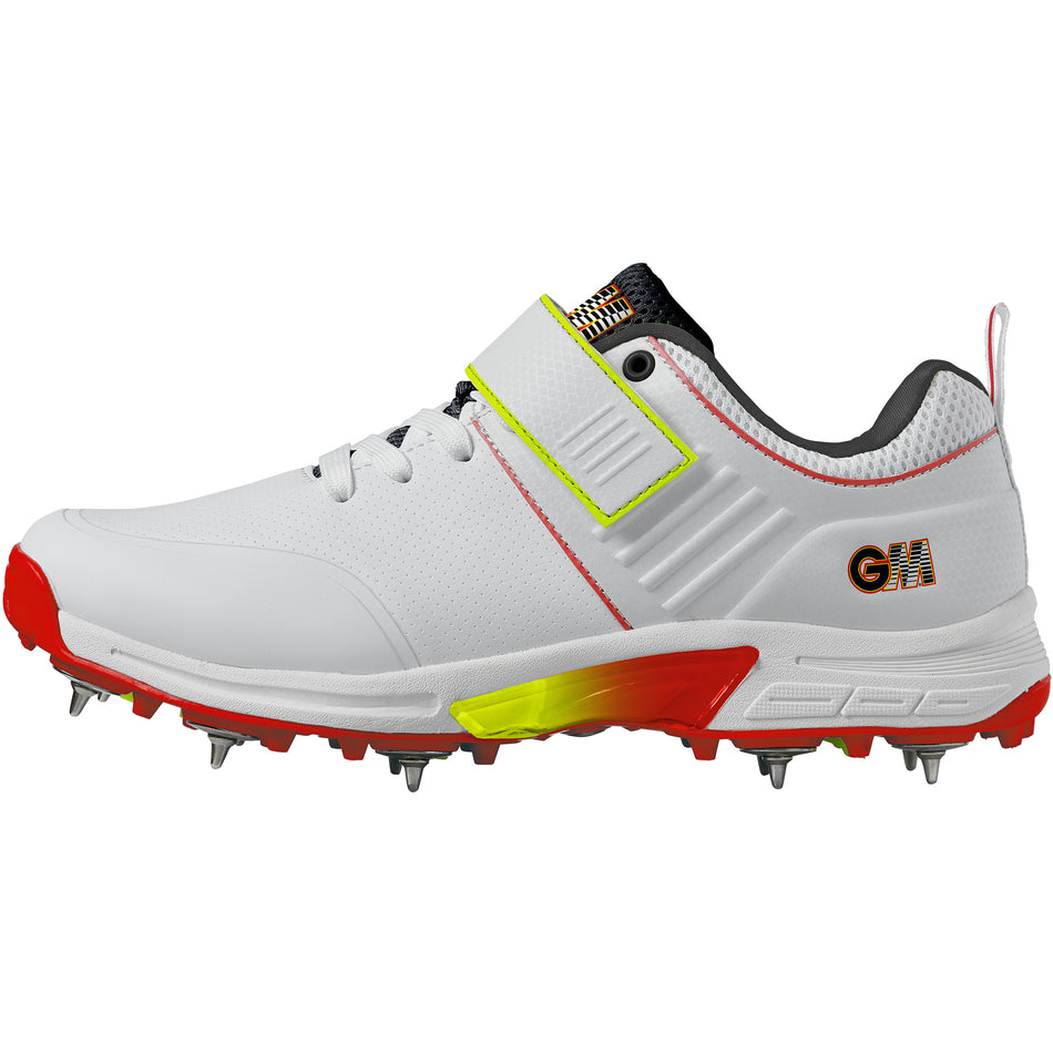 The Gunn & Moore Rival+ Cricket Spikes by Gunn & Moore feature a white design with red and yellow accents, steel spikes for superior grip, lace-up front, Velcro strap over the laces, and bold GM branding—ideal for serious cricketers.