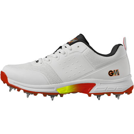 The Gunn & Moore Rival Cricket Spikes are high-performance white shoes with steel spikes, black laces and padded collar, orange-yellow gradient sole accents, red details, and a "GM" logo for a sporty, dynamic look.