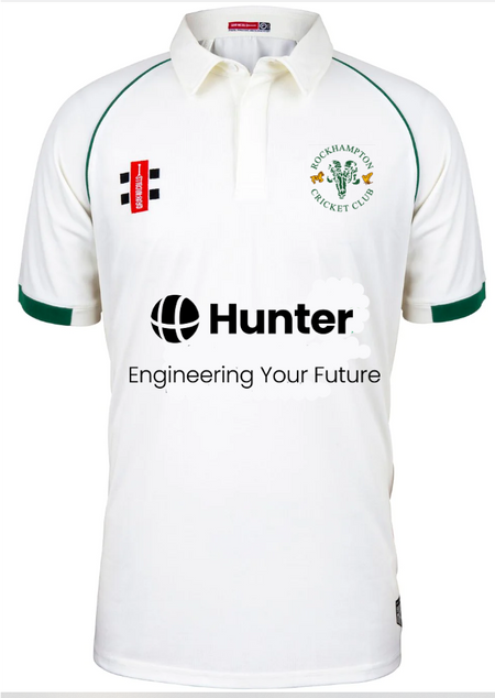 The Rockhampton CC Matrix V2 Playing Shirt - Junior by Gray Nicolls is a white shirt with green trim, displaying the club logo, the Hunter logo with "Engineering Your Future" tagline, and other sponsor logos on chest and sleeve.