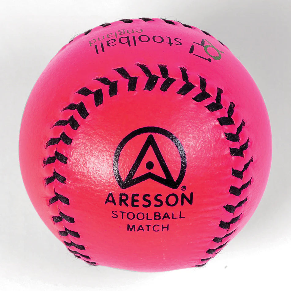 The Aresson Match Stoolball Ball in pink, featuring black stitching and a printed logo, is perfect for Stoolball England matches; pictured here against a white background.