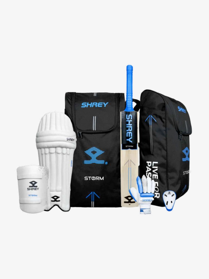 The Shrey Storm Cricket Set (Kashmir Willow) by Shrey includes a bat, two duffle bags (black and blue), batting pads, gloves, thigh and arm guards, and an abdominal guard, all showcased on a white background.