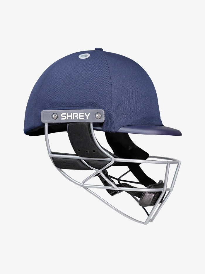 The Shrey Elite Pro Stainless Steel Helmet is a navy blue cricket helmet with a stainless steel grille and high-impact protection, featuring the SHREY logo on the side, set against a plain white background.