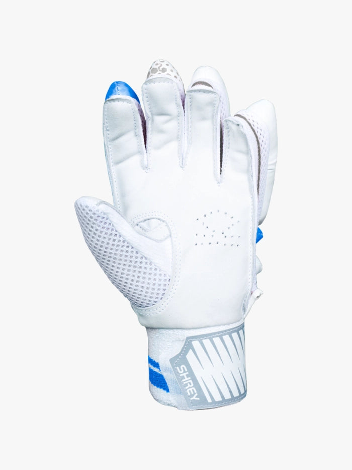 A white Shrey sports glove with blue accents, mesh thumb ventilation, and a gray SAFETY wrist strap—perfect for your Shrey Storm Cricket Set (Kashmir Willow). Glove shown palm-forward with slightly bent fingers.