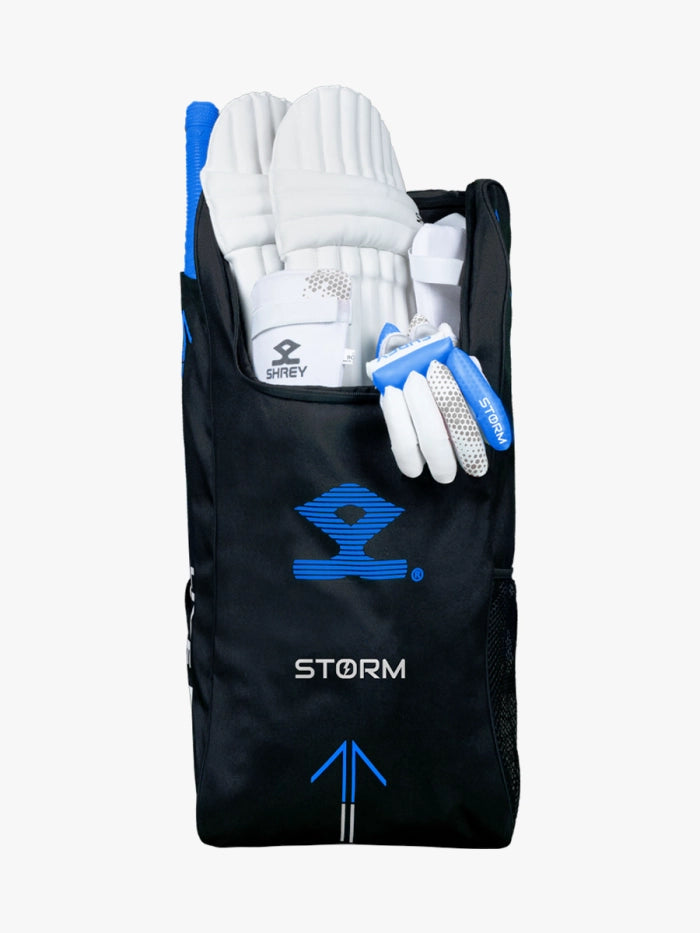 A black and blue Shrey Storm Cricket Set (Kashmir Willow) bag holds pads, gloves, a helmet, and bat; the set's handles and edges are visible at the top.