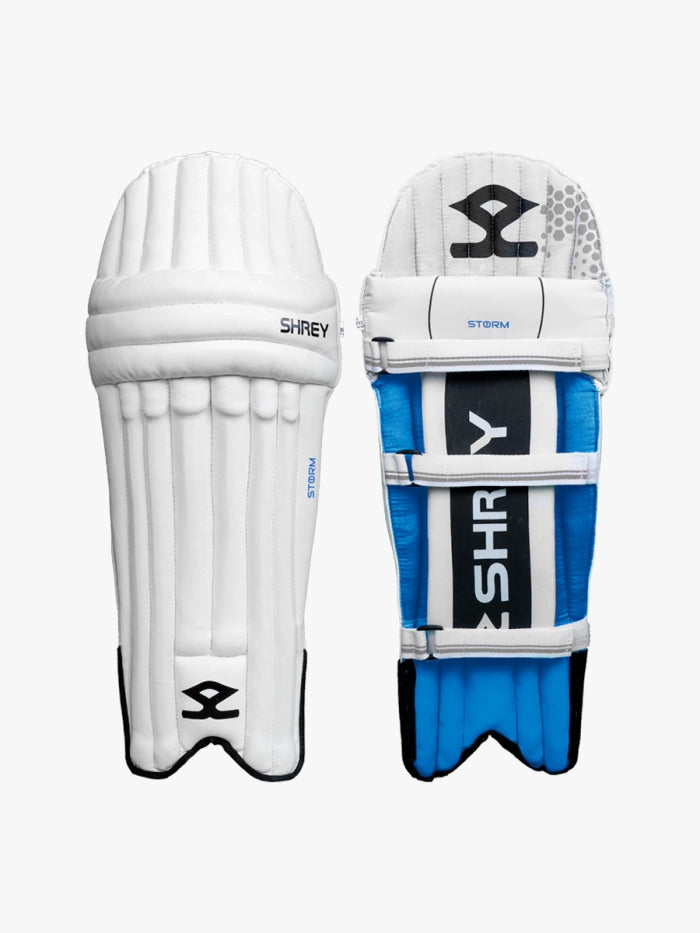 Shrey Storm Cricket Set (Kashmir Willow) batting pads shown front and back: white with black accents in front, blue, white, and black at the back with Shrey branding—ideal for a complete cricket set.