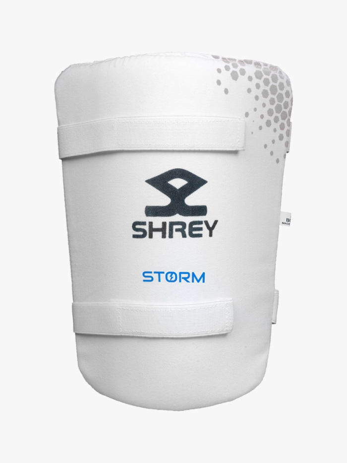 A white cricket thigh pad with a grey dotted design and black SHREY logo, featuring STORM in blue and two Velcro straps—an ideal addition to your Shrey Storm Cricket Set (Kashmir Willow) from Shrey.
