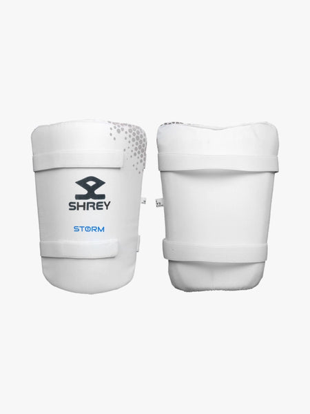 A pair of white Shrey cricket batting thigh pads with "Storm" branding, featuring adjustable straps and a sleek design—ideal to use with the Shrey Storm Cricket Set (Kashmir Willow).