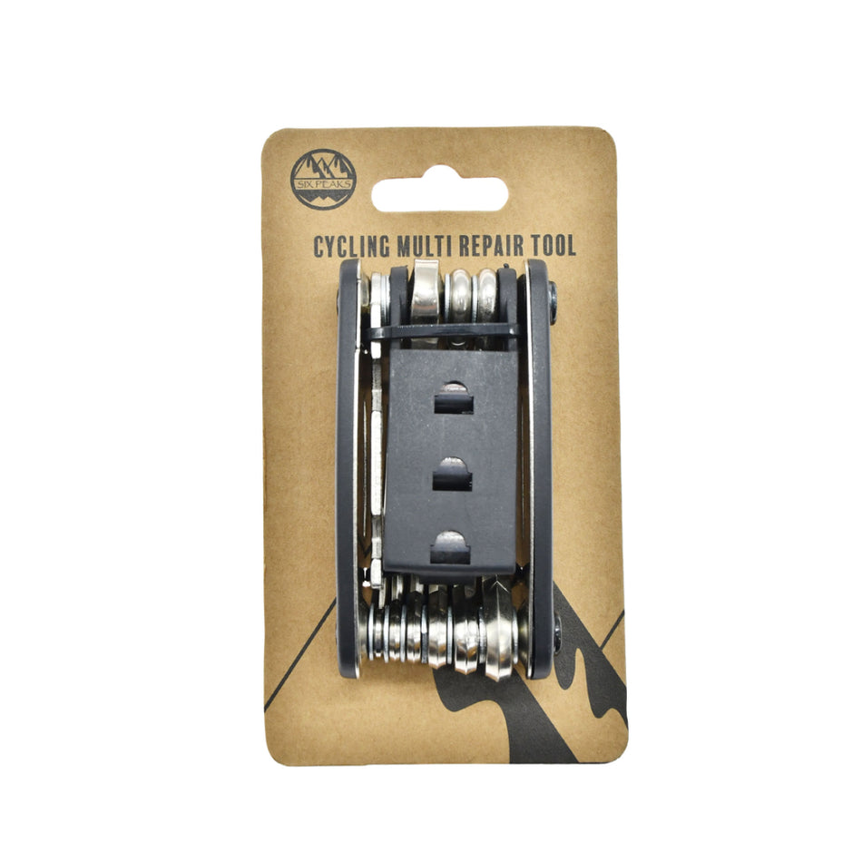 The Six Peaks Cycling Multi Repair Tool by Six Peaks features fold-out metal tools for bike maintenance, packaged on brown cardboard labeled “Six Peaks Cycling Multi Repair Tool” with a mountain logo at the top.