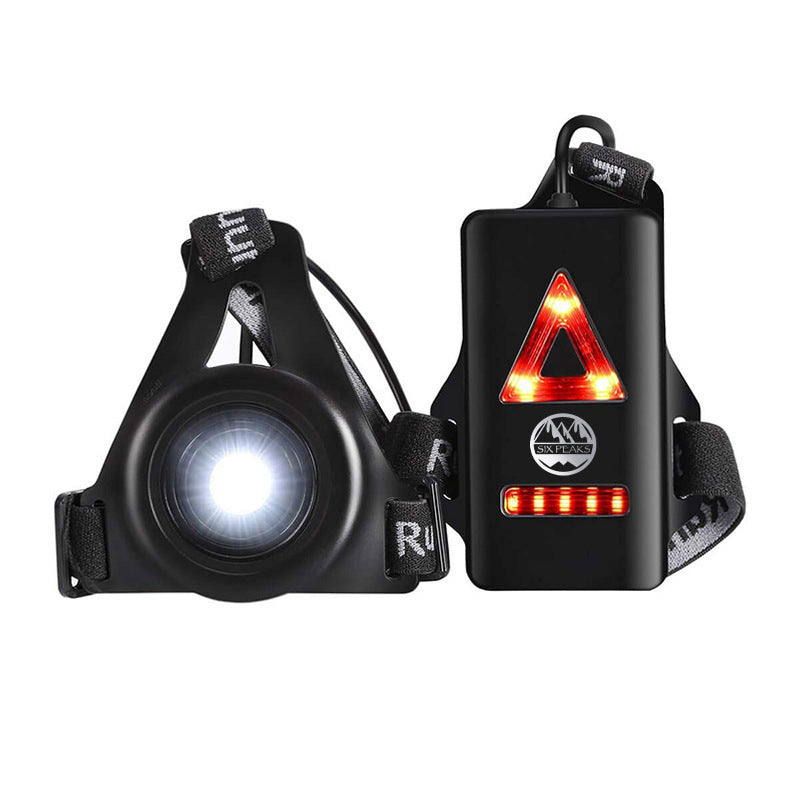 The Six Peaks Running LED Chest Lamp by Six Peaks features a black adjustable strap, bright white front light, and rear red LED warning lights in a triangular shape with horizontal bars for enhanced outdoor safety and visibility.