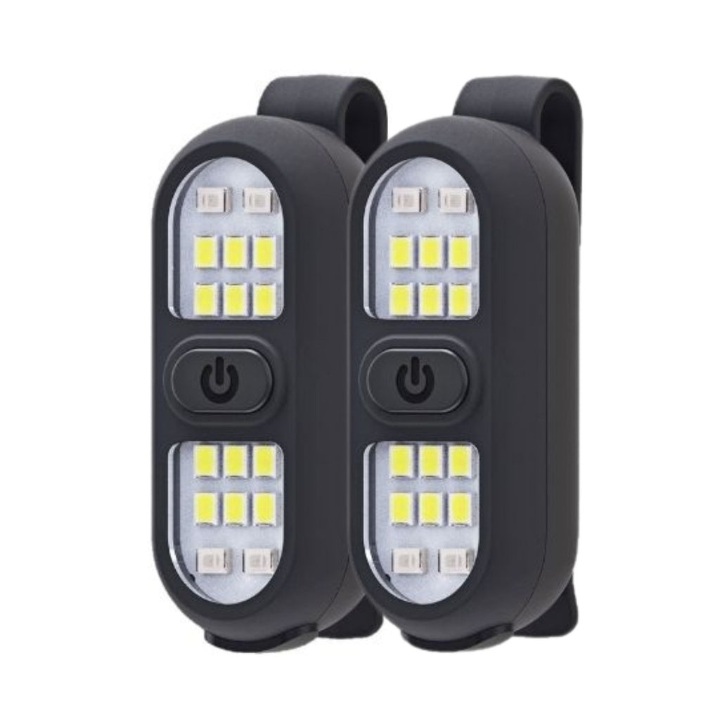 The Six Peaks LED Clip-On Lights by Six Peaks feature a black rectangular design with central power buttons and multiple yellow LEDs for visibility. USB-C rechargeable, each has a back clip for easy attachment. Shown on a white background.