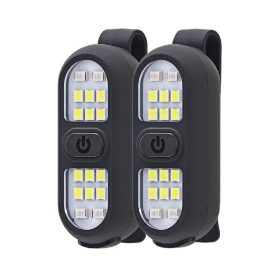 The Six Peaks LED Clip-On Lights by Six Peaks feature a black rectangular design with central power buttons and multiple yellow LEDs for visibility. USB-C rechargeable, each has a back clip for easy attachment. Shown on a white background.
