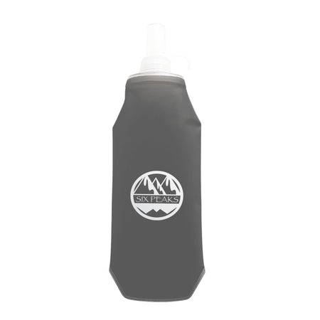The Six Peaks Collapsible Water Bottle is a gray, travel-friendly bottle featuring a white Six Peaks logo with mountain graphics on the front and a transparent nozzle at the top.