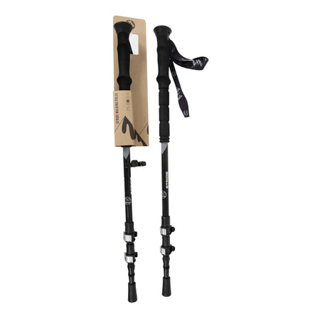 Two black Six Peaks Stride Walking Poles, one attached to packaging and the other fully extended, feature ergonomic foam handles and wrist straps. Both stand upright against a white background, showcasing essential hiking gear from Six Peaks.
