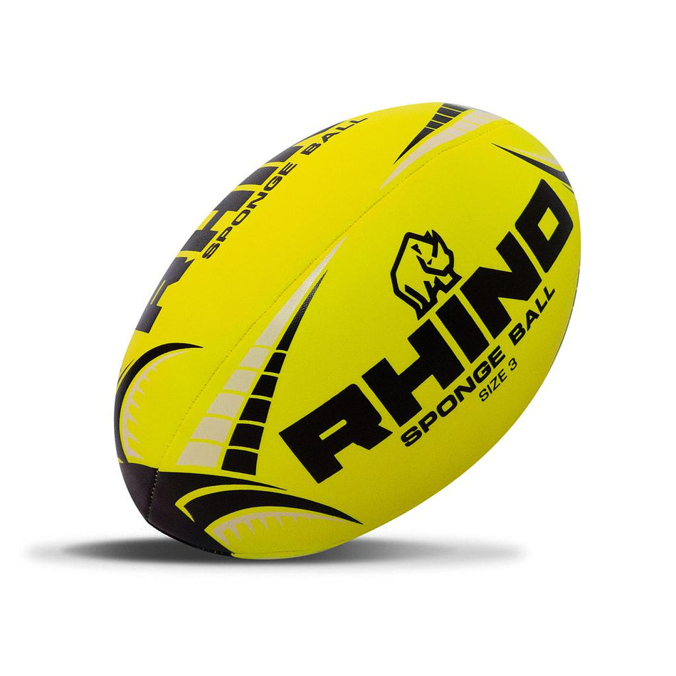 The Rhino Sponge Rugby Ball is a bright yellow size 3 ball with black and gray accents, made from soft foam and featuring the Rhino brand name, rhino logo, and "SPONGE BALL SIZE 3" text.