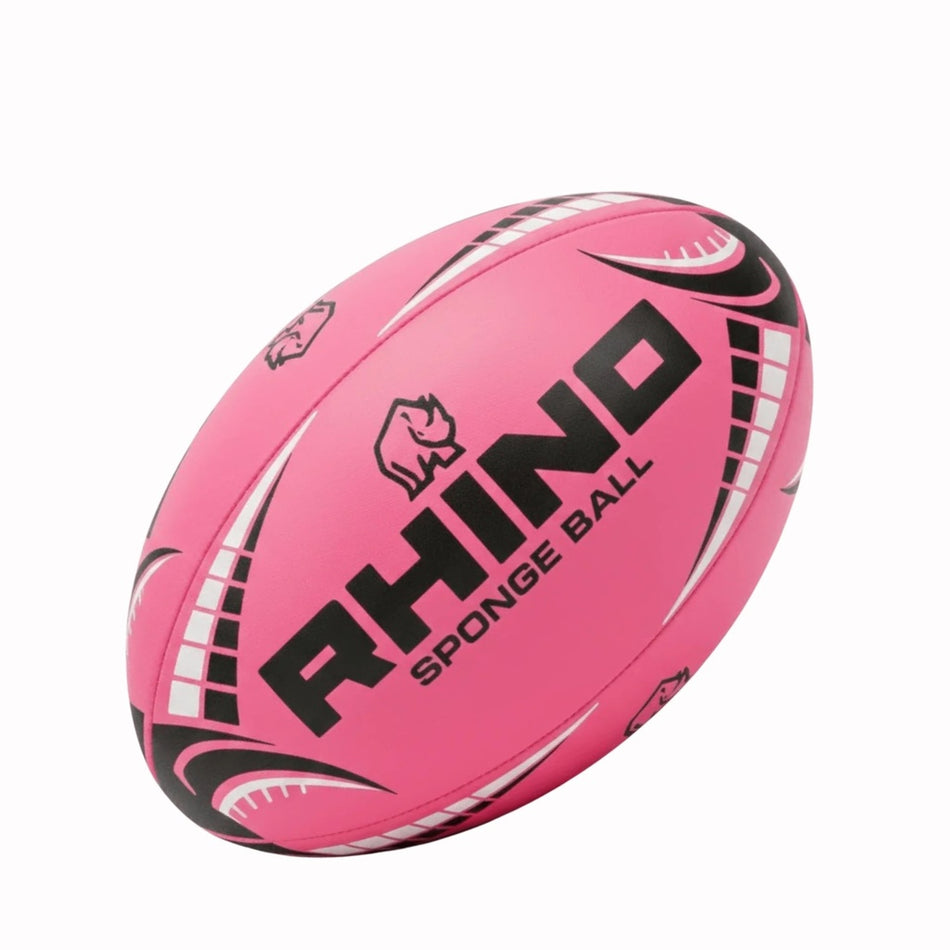 The Rhino Sponge Rugby Ball is a pink, size 3 foam rugby ball with black and white accents, the Rhino brand name, rhinoceros logo, and "SPONGE BALL" text on its surface.