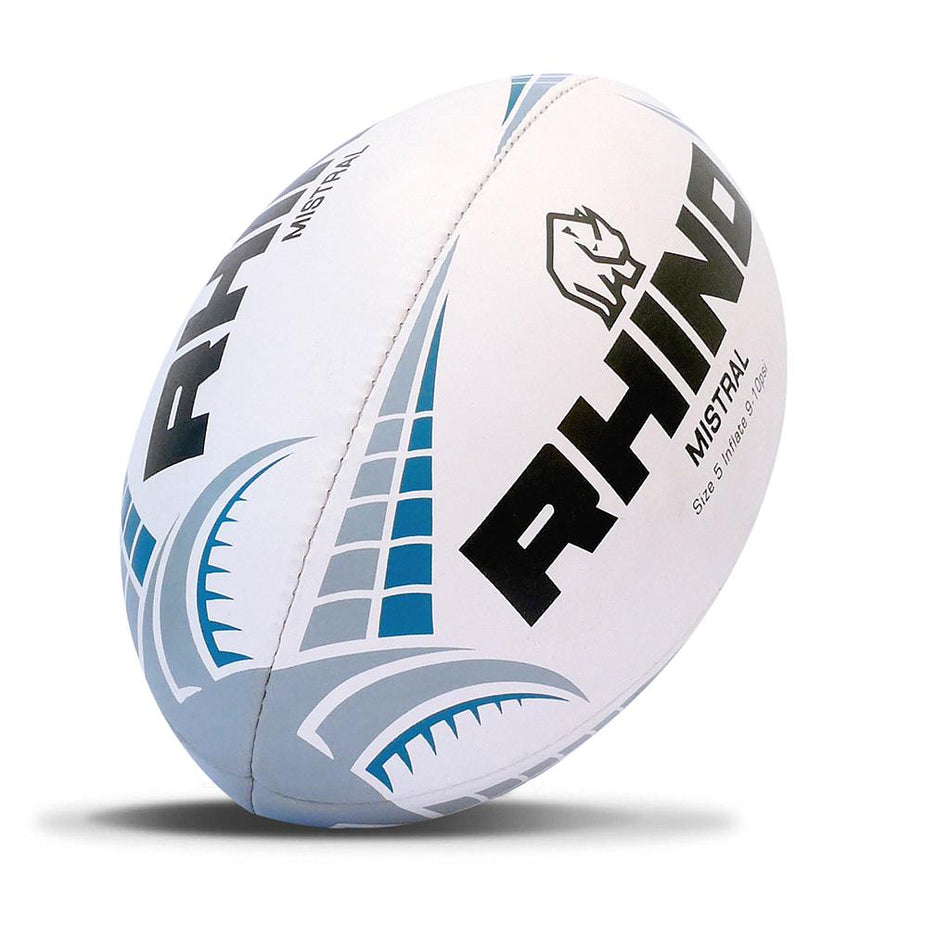 The Rhino Mistral Grip Developer is a white size 5 rugby ball with blue and gray patterns, bold black "RHINO" lettering, and a rhino logo. Designed for senior training, this gripless ball is shown tilted and casting a shadow on a white background.