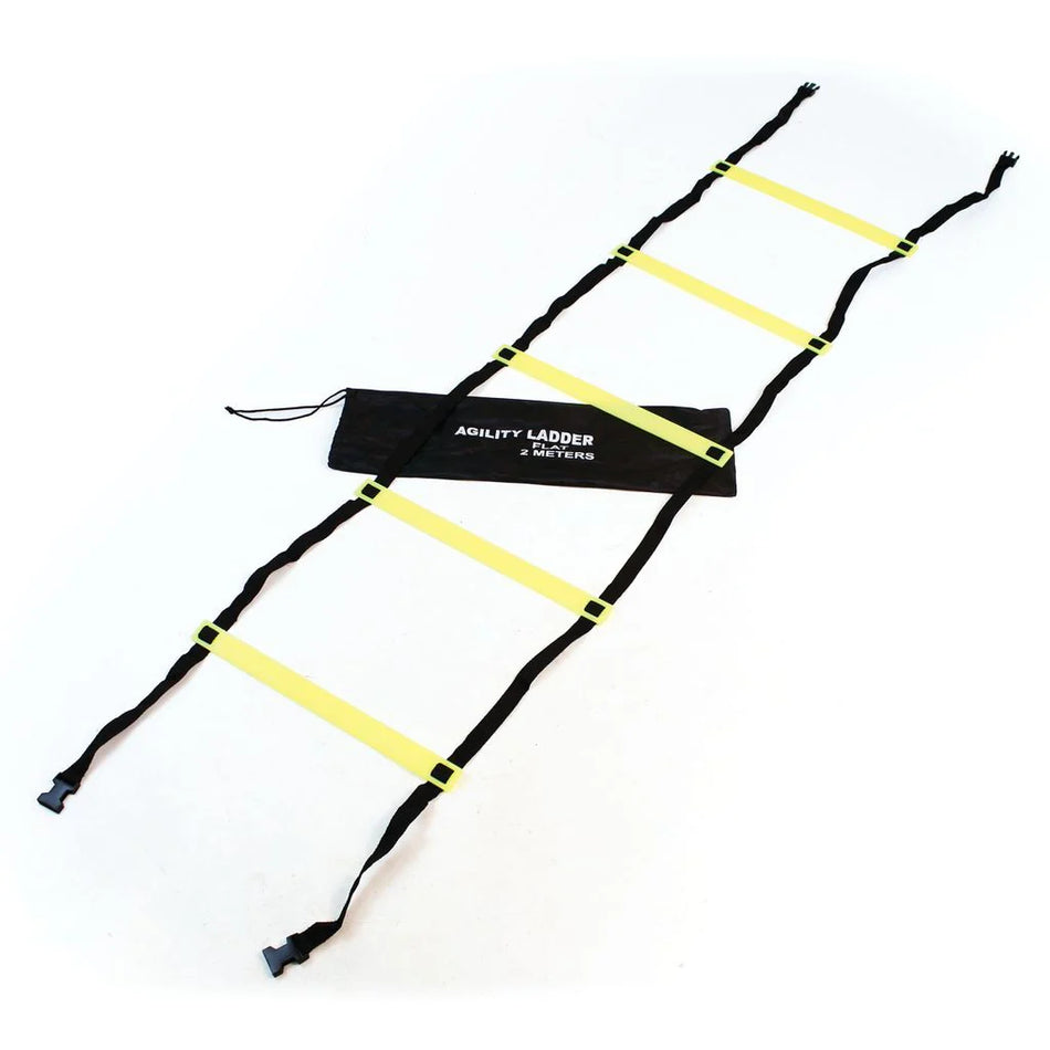 A Wilks Flat Foot Speed Ladder with six yellow and black rungs is arranged on a white surface for footwork training. Beside it lies a black Wilks carrying bag labeled "Agility Ladder.
