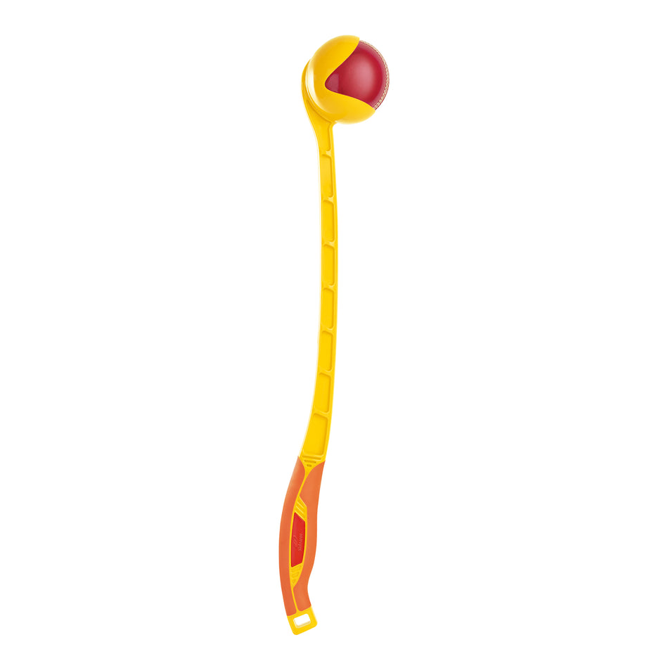 The Sidearm Club Cricket Ball Thrower by Sidearm is a yellow and orange plastic launcher that holds a red ball on top, perfect for cricket batting practice or fetch with dogs. Ideal for fun games, it's shown against a plain white background.