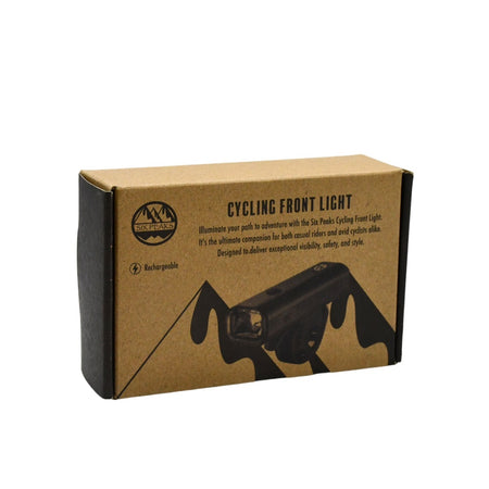 A cardboard box labeled Six Peaks Cycling Front Light with an image of a bike light. The packaging displays the Six Peaks logo and highlights its USB rechargeable design, 400 lumens brightness, visibility, safety, and style.